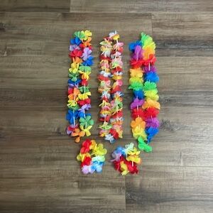 3 multicolored flower leis with two bracelets